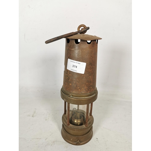 374 - A vintage brass miners lamp - approx. 26cm high