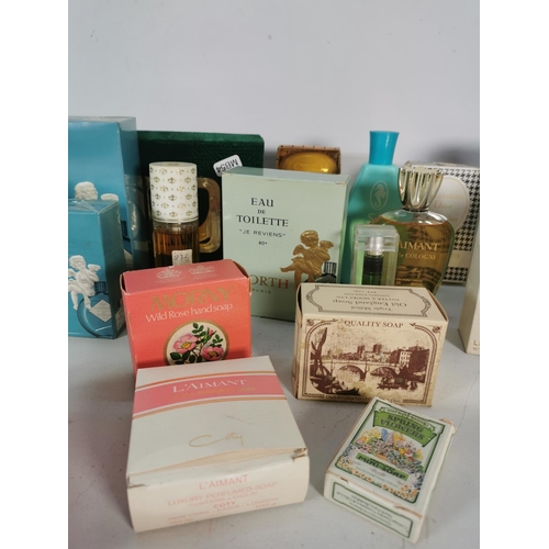 433 - A collection of vintage cosmetics and perfumes to include two as new French Worth of Paris colognes,... 