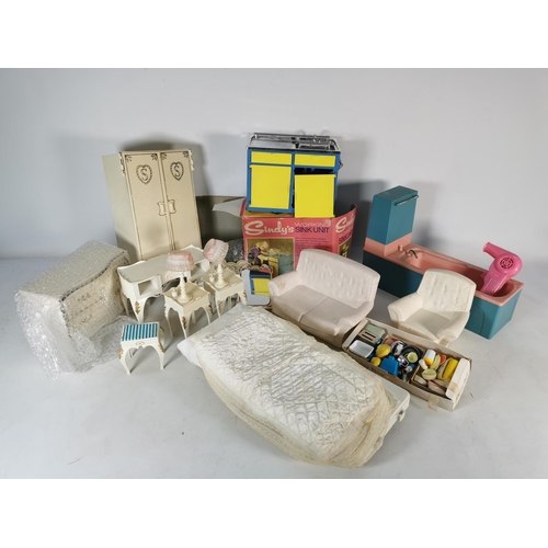 453 - A box containing a large quantity of Sindy accessories to include sofa, armchair, sink unit etc.