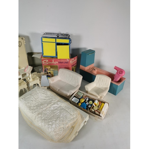 453 - A box containing a large quantity of Sindy accessories to include sofa, armchair, sink unit etc.