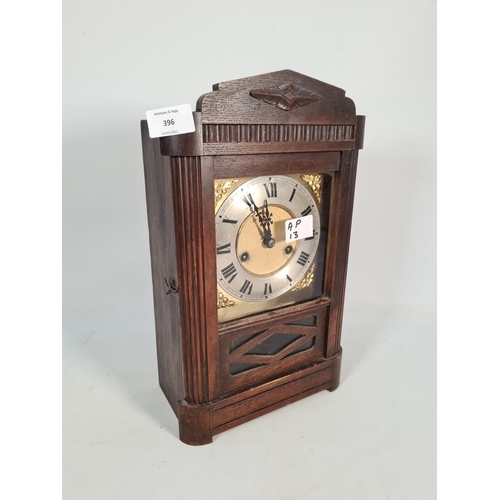 396 - A vintage oak cased chiming mantel clock with brass face, key and pendulum - approx. 37cm high x 23c... 