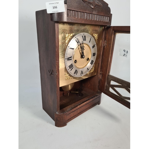 396 - A vintage oak cased chiming mantel clock with brass face, key and pendulum - approx. 37cm high x 23c... 