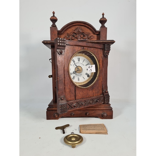 397 - A vintage Fattorini & Sons of Bradford oak cased automatic alarm eight day mantel clock with key - a... 