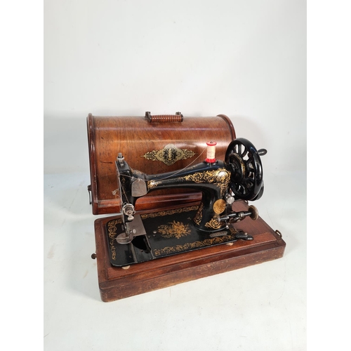 398 - A vintage oak cased Singer sewing machine