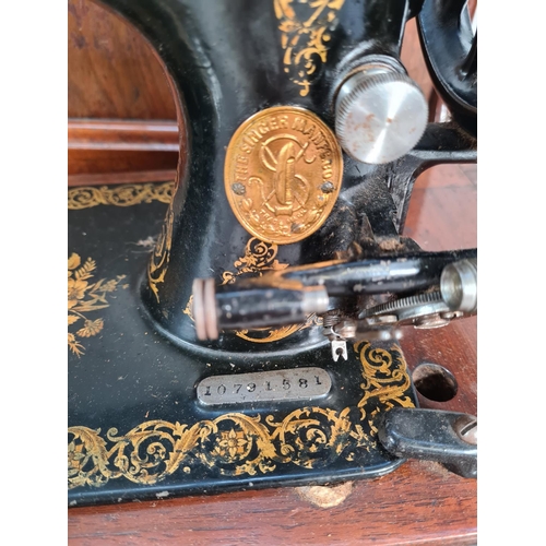 398 - A vintage oak cased Singer sewing machine