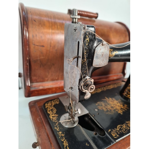 398 - A vintage oak cased Singer sewing machine