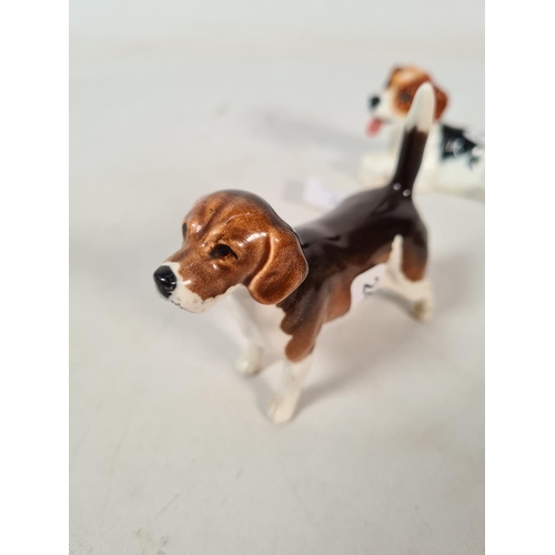 283 - Two ceramic dog figurines, one Beswick Champion Wendover Billy beagle - approx. 8.5cm high and one R... 