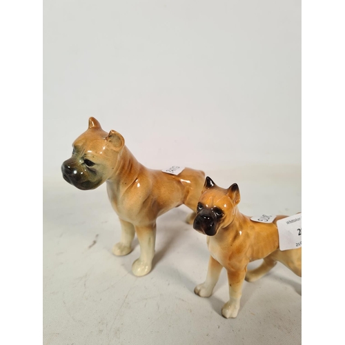 284 - Two ceramic boxer dog figurines - largest approx. 12cm high