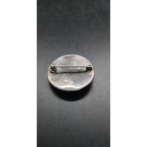 113 - A hallmarked Birmingham silver and green enamel circular pin brooch - approx. gross weight 6 grams a... 