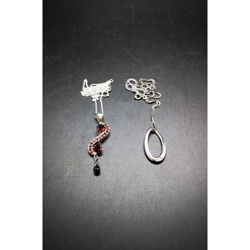 125 - Two 925 silver pendant necklaces, one garnet pendant and one 925 silver CZ pendant - approx. gross w... 