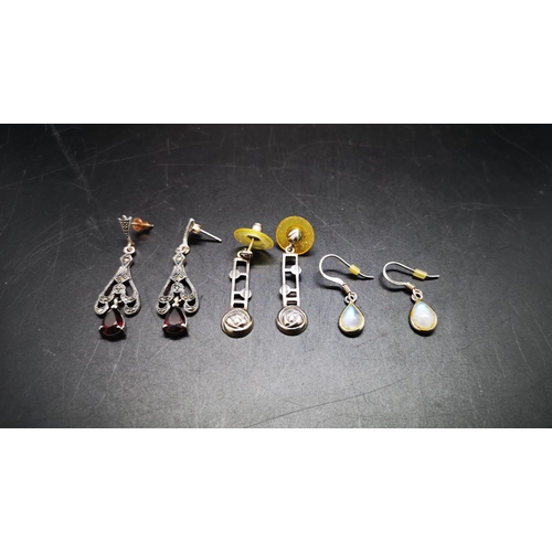 141 - Three pairs of 925 silver earrings, one opalescent, one Kit Heath Macintosh style and one garnet - a... 