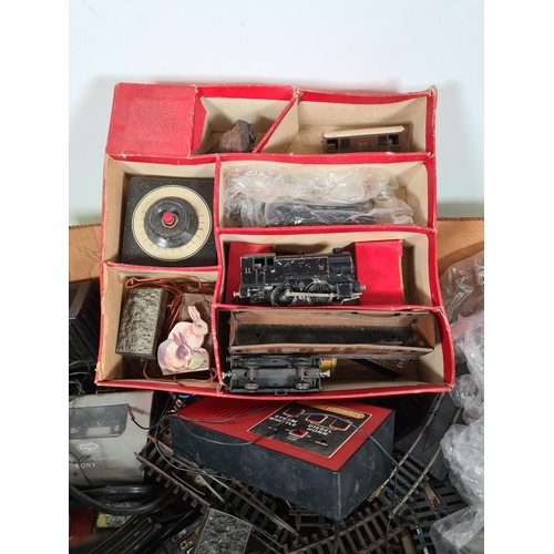 460 - A box containing a large quantity of model railway accessories to include track, power units, passen... 