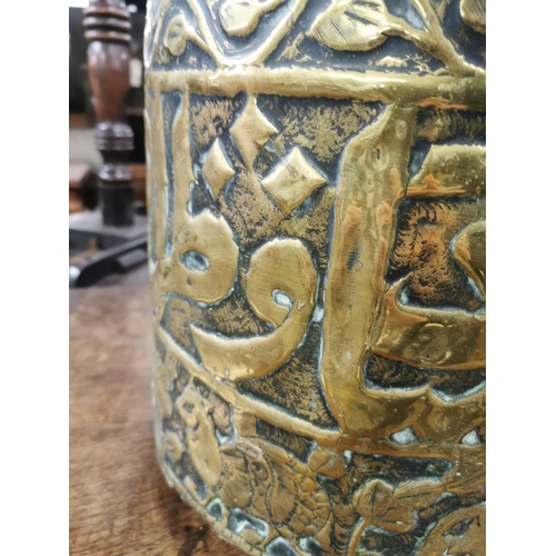 478 - A Middle Eastern embossed brass coal bucket with elephant and lion design - approx. 28cm high x 32cm... 