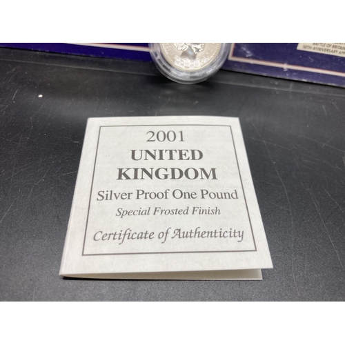 223 - Three items, one cased Royal Mint 2001 92.5% silver proof frosted finish £1 coin and two Royal Mint ... 