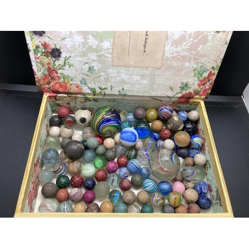 236 - A French 'Au Vieil Acacia' book jewellery box containing assorted Victorian marbles