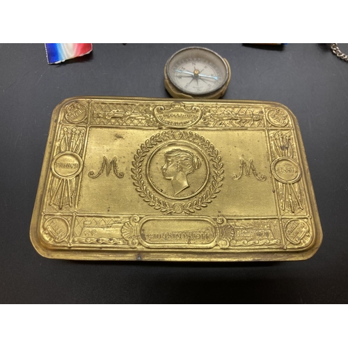 237 - A 1914 WWI Princess Mary chocolate tin containing various items to include vintage German compass, W... 