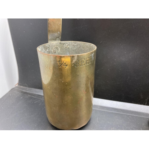 238 - A set of four vintage brass graduating measuring cups, two stamped 'The Oriental Metal Dressing Work... 