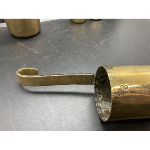 238 - A set of four vintage brass graduating measuring cups, two stamped 'The Oriental Metal Dressing Work... 