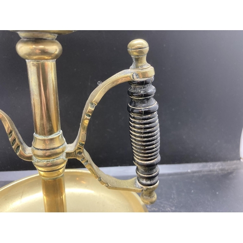 240 - A 19th century brass chamberstick with ebonised handle - approx. 19cm high