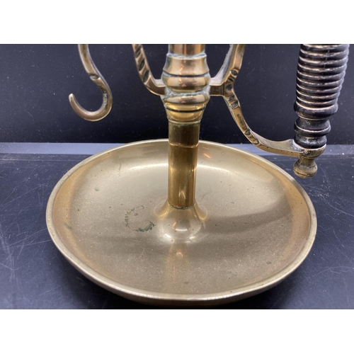 240 - A 19th century brass chamberstick with ebonised handle - approx. 19cm high