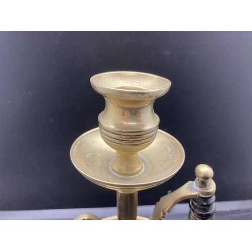 240 - A 19th century brass chamberstick with ebonised handle - approx. 19cm high