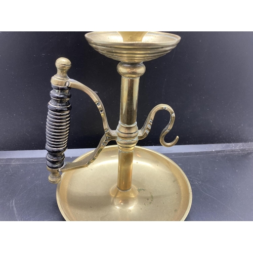 240 - A 19th century brass chamberstick with ebonised handle - approx. 19cm high