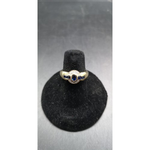 89 - A hallmarked 14ct gold sapphire and diamond ring with one central sapphire, six outer sapphires and ... 