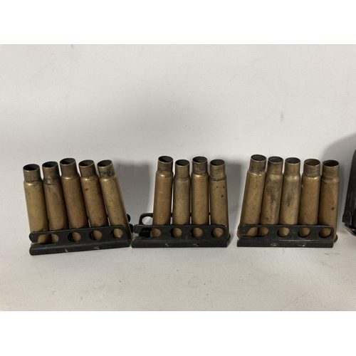 72 - Three 303 rifle clips with magazine