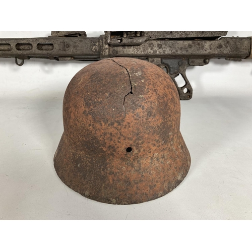 85 - A WWII German MG42 machine gun relic and helmet, found together on the Eastern Front in the area of ... 