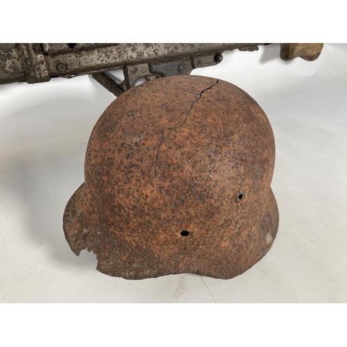 85 - A WWII German MG42 machine gun relic and helmet, found together on the Eastern Front in the area of ... 