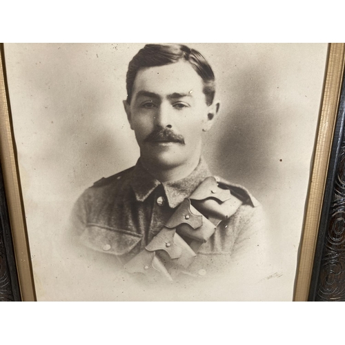 92A - A framed photograph of a WWI British soldier