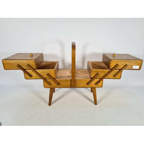 160 - An 1950s beech and bentwood cantilever sewing box