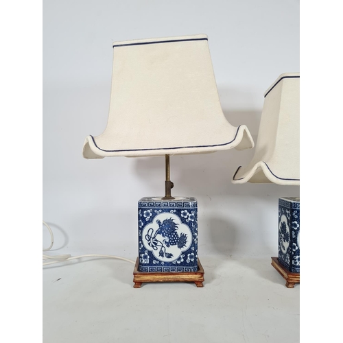 180 - A pair of oriental style blue and white ceramic bedside lamps with white and blue shades - approx. 5... 