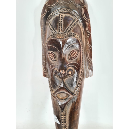 187 - A vintage African carved hardwood wall hanging tourist mask - approx. 69cm high x 19cm wide