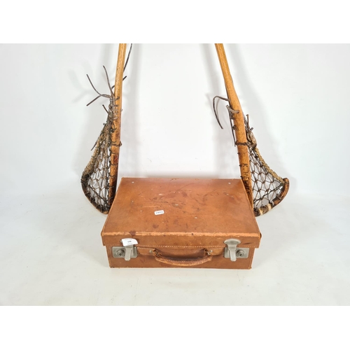 198 - Three items, two vintage lacrosse sticks and one tanned leather briefcase