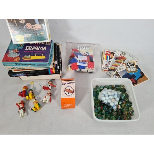 215 - A collection of vintage games to include 'Tower of Brahma' puzzle play, marbles etc.