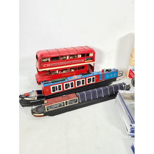 217 - Various items to include two handmade and painted narrow boats, one vintage style London double deck... 