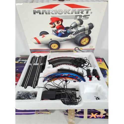 218 - Two items, one boxed Carrera Go Mario Kart DS slot car set and one box of Scalextric Le Mans advance... 