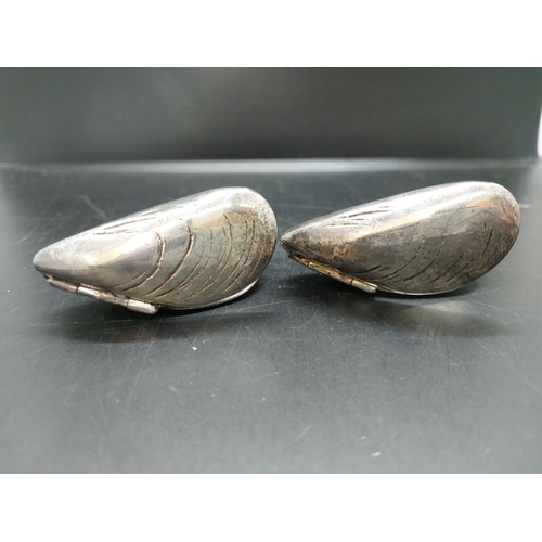 124 - A hallmarked English silver cased cheroot, a pair of silver plated mussel shells in the manner of Sa... 