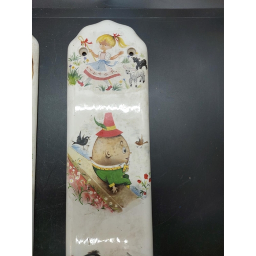 151 - Two mid 20th century porcelain push plates in the manner of Mabel Lucie Atwell with impressed marks ... 