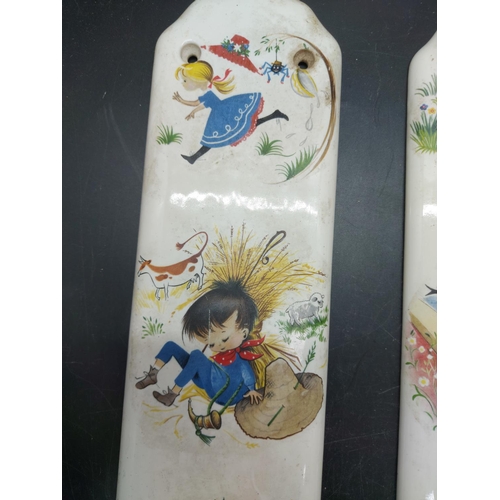 151 - Two mid 20th century porcelain push plates in the manner of Mabel Lucie Atwell with impressed marks ... 