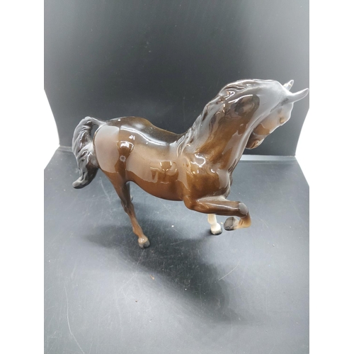 152 - Three figurines to include a Beswick prancing brown horse, Beswick pony and one other