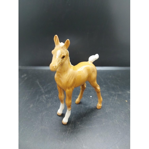 152 - Three figurines to include a Beswick prancing brown horse, Beswick pony and one other