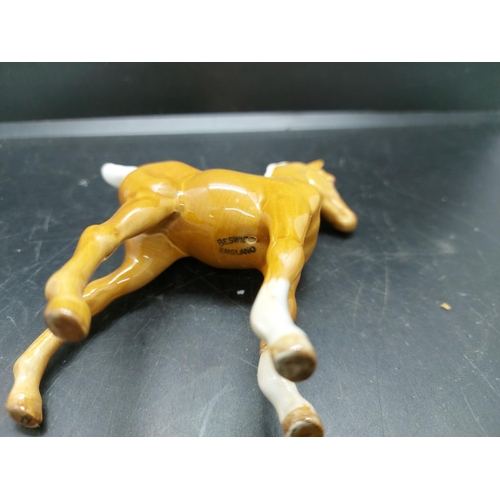 152 - Three figurines to include a Beswick prancing brown horse, Beswick pony and one other