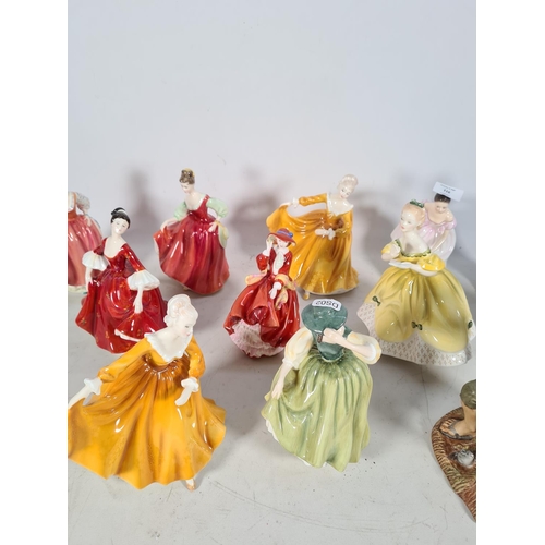 116 - Twelve Royal Doulton figurines to include two 'Fair Lady' HN 2832, two 'Kirsty' HN 2381, 'Buttercup'... 