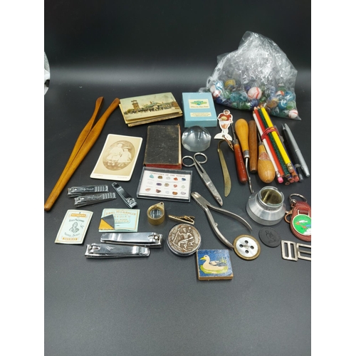 73 - A collection of assorted items to include various marbles, pencils, sewing items etc.