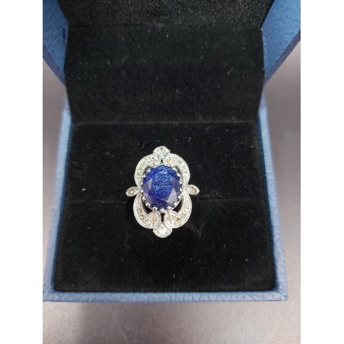 120 - A 925 silver and 7ct blue sapphire ring with outer rose cut 0.60ct diamonds