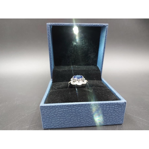 120 - A 925 silver and 7ct blue sapphire ring with outer rose cut 0.60ct diamonds