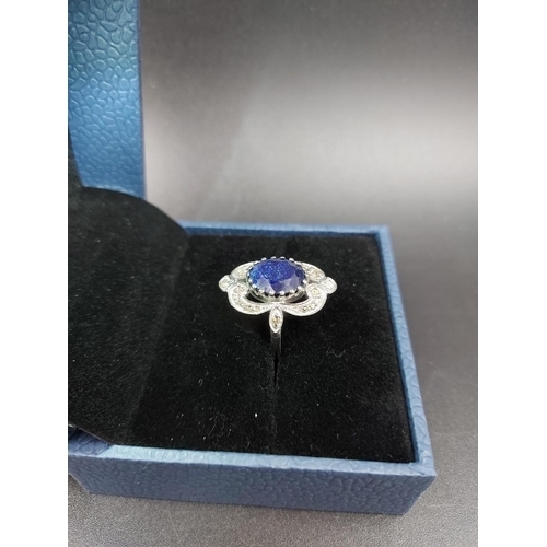 120 - A 925 silver and 7ct blue sapphire ring with outer rose cut 0.60ct diamonds