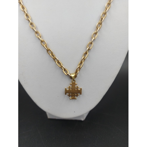 136 - A stamped 18ct yellow gold Israelite cross pendant with 55cm yellow metal chain - approx. pendant gr... 